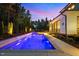 Inviting backyard pool with waterfall feature and elegant home exterior at twilight at 30 Futrell Ridge Ct, Chapel Hill, NC 27517