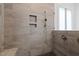 Modern shower featuring stylish tile work, built-in niche, and glass enclosure at 30 Futrell Ridge Ct, Chapel Hill, NC 27517