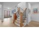 Elegant staircase with wooden steps, black iron railings, and natural light at 30 Futrell Ridge Ct, Chapel Hill, NC 27517