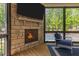 Close up on the sunroom with a fireplace, TV, and views of the pool and backyard at 30 Futrell Ridge Ct, Chapel Hill, NC 27517