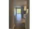 View from hallway to a living room with sliding door access to a balcony or patio at 3049 Huntleigh Dr, Raleigh, NC 27604