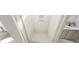 Bathroom shower with white tiling and glass door at 328 Beacon Dr, Pittsboro, NC 27312