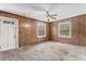 Spacious bedroom featuring wood paneling, carpeted floors, and two windows at 331 Highland Ave, Burlington, NC 27217