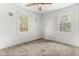 Bright bedroom boasting two windows, white painted walls, and a ceiling fan at 331 Highland Ave, Burlington, NC 27217