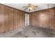 Bedroom features wood paneling, a ceiling fan, and carpeted floors at 331 Highland Ave, Burlington, NC 27217