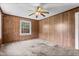Bedroom features wood paneling, a ceiling fan, and carpeted floors at 331 Highland Ave, Burlington, NC 27217