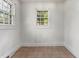 Bright room featuring painted paneling and two windows that let in natural light at 331 Highland Ave, Burlington, NC 27217