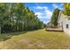 Expansive backyard with a wooden deck and lush greenery creates a private oasis for relaxation and outdoor enjoyment at 3608 Deering Dr, Raleigh, NC 27616