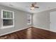 Comfortable bedroom with hardwood floors, a ceiling fan, and abundant natural light at 3608 Deering Dr, Raleigh, NC 27616