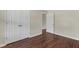 This bedroom offers two closets, a neutral color scheme, and dark wood-look floors at 3608 Deering Dr, Raleigh, NC 27616