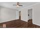 Inviting bedroom showcasing hardwood floors, ceiling fan, and a glimpse into an adjacent bathroom at 3608 Deering Dr, Raleigh, NC 27616