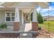Inviting front porch with brick columns, offering a warm welcome to the home at 3608 Deering Dr, Raleigh, NC 27616