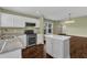Bright kitchen features stainless appliances, granite countertops, and an island with seating at 3608 Deering Dr, Raleigh, NC 27616