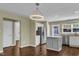 Open kitchen boasts stainless appliances, an island, and a dining area bathed in natural light at 3608 Deering Dr, Raleigh, NC 27616