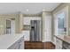Bright kitchen with stainless refrigerator, white cabinets, and an island, perfect for modern living at 3608 Deering Dr, Raleigh, NC 27616