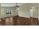Bright living room with hardwood floors, ceiling fan, and large windows for natural light at 3608 Deering Dr, Raleigh, NC 27616