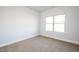 Bright bedroom with neutral carpet and a large window at 37 Shoreline Dr, Lillington, NC 27546