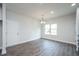 Bright dining area with wood-look flooring and modern chandelier with large window at 37 Shoreline Dr, Lillington, NC 27546