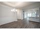 Open-concept dining room flowing into the kitchen; featuring a chandelier, wainscoting, and sleek floors at 37 Shoreline Dr, Lillington, NC 27546