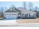 Charming single-story home featuring a two-car garage and well-manicured front yard at 37 Shoreline Dr, Lillington, NC 27546