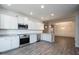 Modern kitchen features white cabinets, stainless steel appliances, and a granite countertop at 37 Shoreline Dr, Lillington, NC 27546