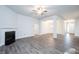 Bright, open living room featuring a fireplace and stylish gray flooring, flowing into the dining area at 37 Shoreline Dr, Lillington, NC 27546