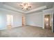 Spacious main bedroom boasts tray ceiling, neutral carpeting, and walk-in closet at 37 Shoreline Dr, Lillington, NC 27546