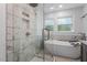 Elegant bathroom featuring a glass-enclosed shower and a standalone tub, creating a spa-like retreat at 3725 Fernwood Dr, Raleigh, NC 27612