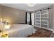 Charming bedroom with wood floors and modern sliding closet doors, offering a blend of style and functionality at 3725 Fernwood Dr, Raleigh, NC 27612