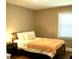 Bedroom featuring hardwood floors, natural lighting, and an accompanying nightstand at 3725 Fernwood Dr, Raleigh, NC 27612