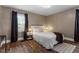Cozy bedroom with wood floors, neutral walls, and a comfortable bed, creating a serene retreat at 3725 Fernwood Dr, Raleigh, NC 27612