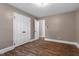 Bedroom featuring hardwood floors, neutral wall paint, and white baseboard molding at 3725 Fernwood Dr, Raleigh, NC 27612