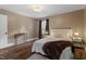 Bedroom featuring hardwood floors, natural lighting, and decorative lighting fixtures at 3725 Fernwood Dr, Raleigh, NC 27612