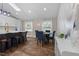 Well-lit dining area with wooden floors features blue velvet chairs, creating a cozy space for dining and gatherings at 3725 Fernwood Dr, Raleigh, NC 27612