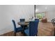 Charming dining area features modern wainscotting and stylish blue velvet chairs, perfect for entertaining guests at 3725 Fernwood Dr, Raleigh, NC 27612
