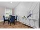 Modern dining room with beautiful floors, wainscotting and a white sideboard with geometric detail, offering ample space at 3725 Fernwood Dr, Raleigh, NC 27612