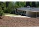Charming one-story house with a spacious driveway and carport, complemented by a well-maintained lawn and mature trees at 3725 Fernwood Dr, Raleigh, NC 27612