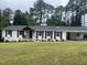 Charming home with dark shutters, a covered porch, lush lawn, and an attached carport at 3725 Fernwood Dr, Raleigh, NC 27612