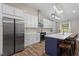 Gourmet kitchen boasts stainless steel appliances, custom white cabinetry, and a quartz-topped island at 3725 Fernwood Dr, Raleigh, NC 27612