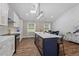 Charming kitchen features a navy blue island, skylight, stainless appliances, and an adjacent dining area at 3725 Fernwood Dr, Raleigh, NC 27612