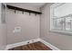 Functional laundry area with dark wood-look flooring and a window for natural light at 3725 Fernwood Dr, Raleigh, NC 27612
