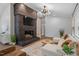 This living room features an accent wall, white sofa, brick fireplace with tv, and natural light at 3725 Fernwood Dr, Raleigh, NC 27612