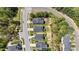 An aerial view of houses on a tree-lined street featuring well-maintained lawns at 4009 Reunion Creek Pkwy, Apex, NC 27539