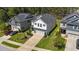 Aerial view of a two-story home featuring a garage, stone accents, neutral siding, and pleasant landscaping at 4009 Reunion Creek Pkwy, Apex, NC 27539