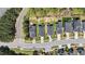 An aerial view of homes on a street featuring well-maintained lawns and mature trees at 4009 Reunion Creek Pkwy, Apex, NC 27539