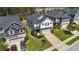 Aerial view of a two-story home featuring a garage, stone accents, neutral siding, and pleasant landscaping at 4009 Reunion Creek Pkwy, Apex, NC 27539