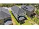 Aerial view of a backyard with a screened porch, lawn, and an air conditioning unit against the home at 4009 Reunion Creek Pkwy, Apex, NC 27539
