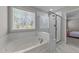 Bright bathroom features a tub, shower, and window offering natural light at 4009 Reunion Creek Pkwy, Apex, NC 27539