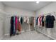 Spacious walk-in closet featuring ample storage and organization racks for clothing at 4009 Reunion Creek Pkwy, Apex, NC 27539