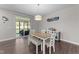 Bright dining room with a modern chandelier and sliding door to an outdoor patio at 4009 Reunion Creek Pkwy, Apex, NC 27539